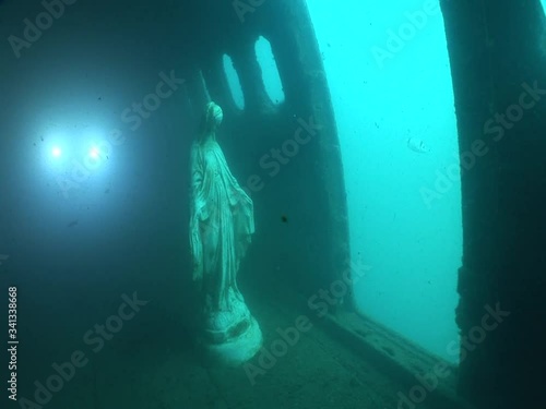 mother Mary statue underwater in an airplane wreck  ocean scenery photo