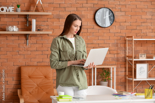 Beautiful young woman worki...