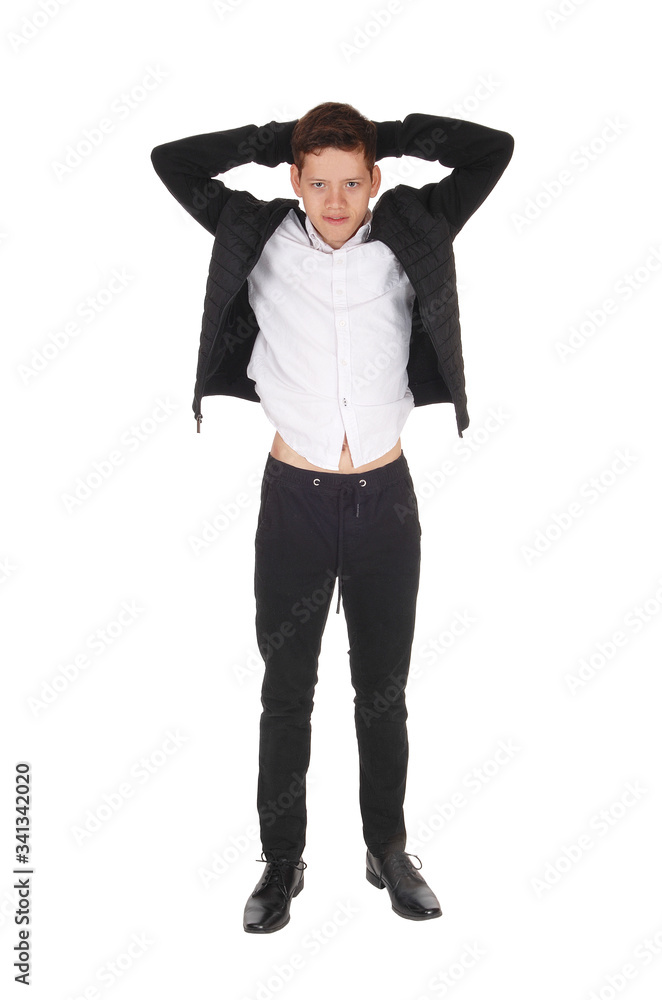 Young teenager standing with hands behind head Young teenager standing with hands behind head