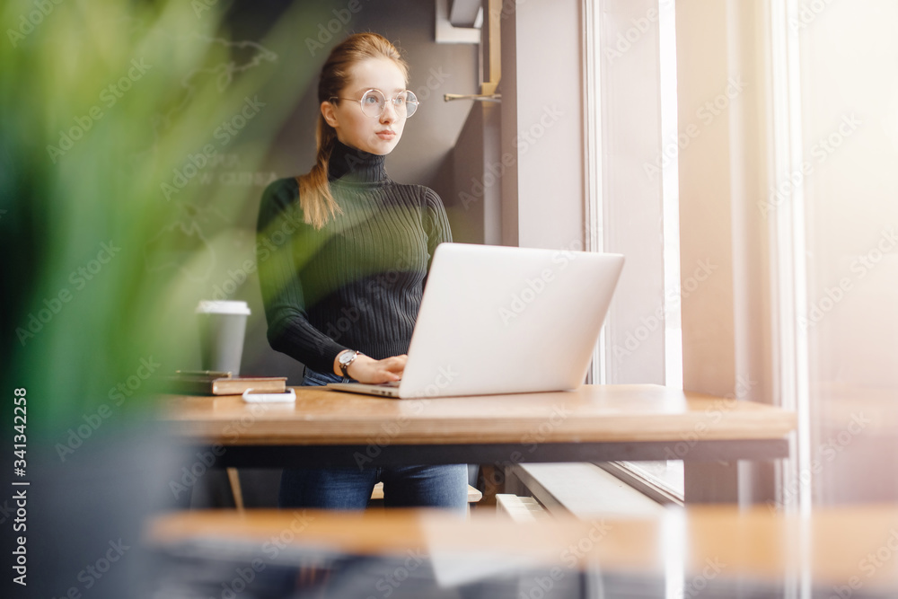 Young female businessman conducts business online computer home with coffee mug, while quarantine from coronavirus in country Young female businessman conducts business online computer home with coffee mug, while quarantine from coronavirus in country