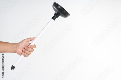 Hand holding toilet black rubber plunger or toilet suction cup
