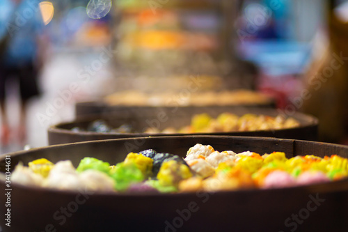 Photography Colorful steamed dim sum, chinese dumpling in a wooden steamer
