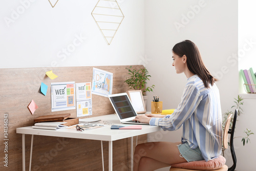 Young female designer worki...