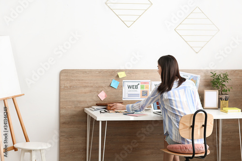 Young female designer worki...