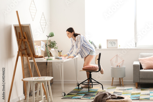 Young female designer worki...