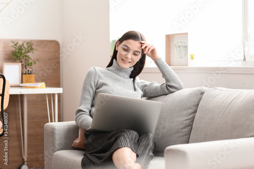 Young woman with laptop wor...