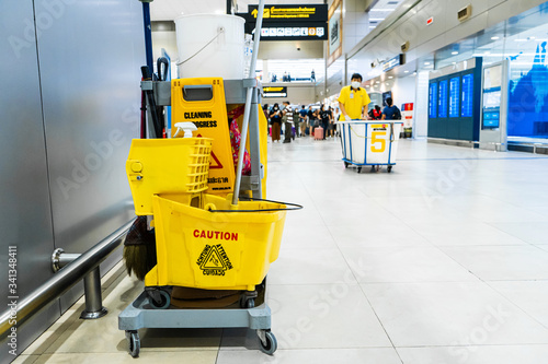 A set of tools and plates for mopping at the airport. Yellow bucket plates and brushes. Cleaning Service