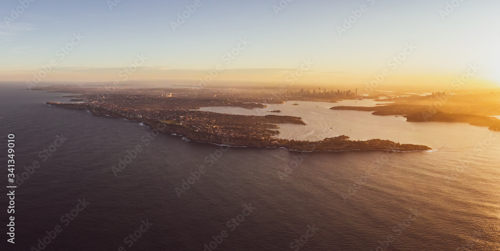 XXL panoramic sunset aerial drone view of South Head, a headland to the north of the suburb of Watsons Bay in Sydney, New South Wales, Australia. Sydney Harbour, CBD & Harbour Bridge in the background