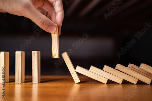 Canvas Print Stop the domino effect by pulling out one piece