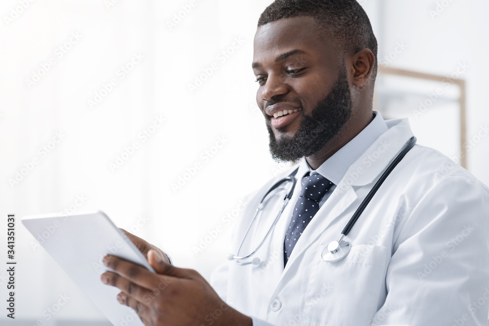 Smiling african american medical doctor holding digital tablet Smiling african american medical doctor holding digital tablet