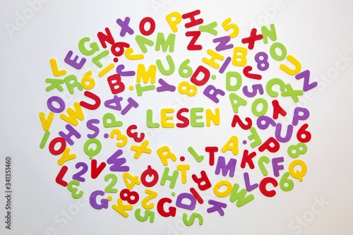 german word LESEN - reading - and seamless pattern with letters of the alphabet and numbers in random order on a white background. Education and Back to school concept