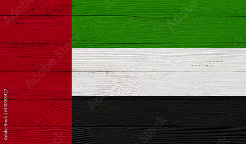 United Arab Emirates flag on a wooden texture. Wood texture, planks Wooden texture background flag. Flag painted with paints on wood