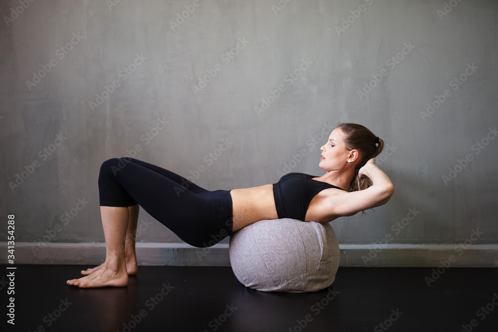 young woman doing exercise on a ball young woman doing exercise on a ball