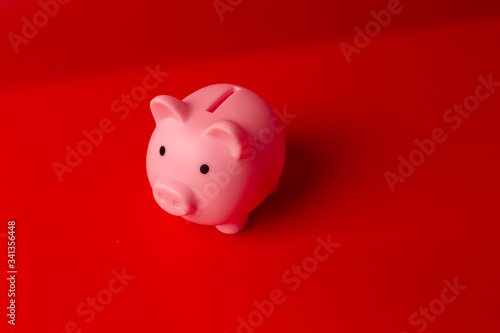 Piggy bank on red background