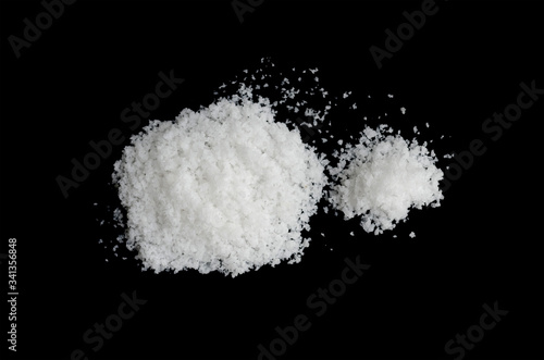  salt on a black background,salt on wooden spoon isolated on white background,A pile of coarse salt on a black background