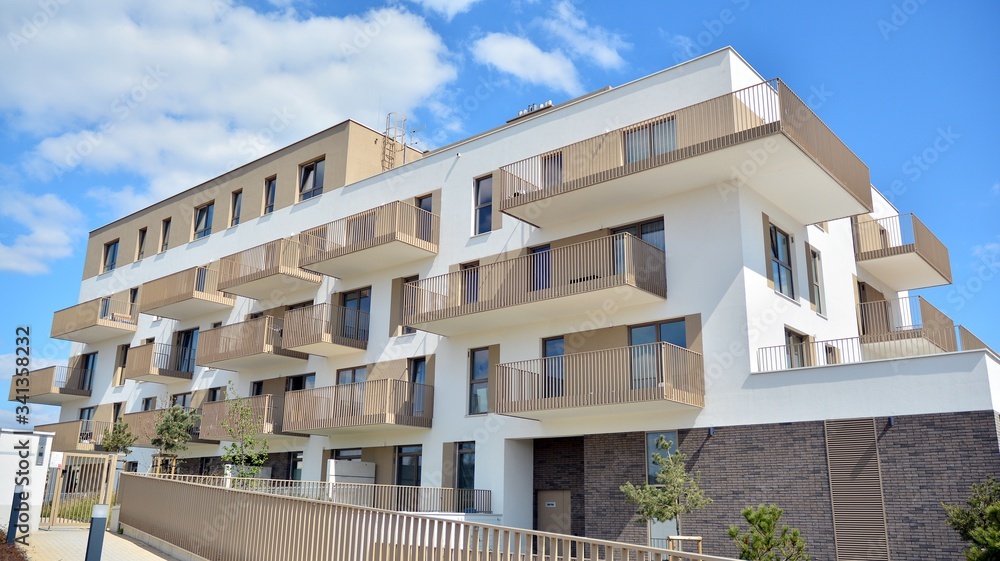 Modern apartment building on a sunny day with a blue sky. Facade of a modern apartment. Modern apartment building on a sunny day with a blue sky. Facade of a modern apartment.