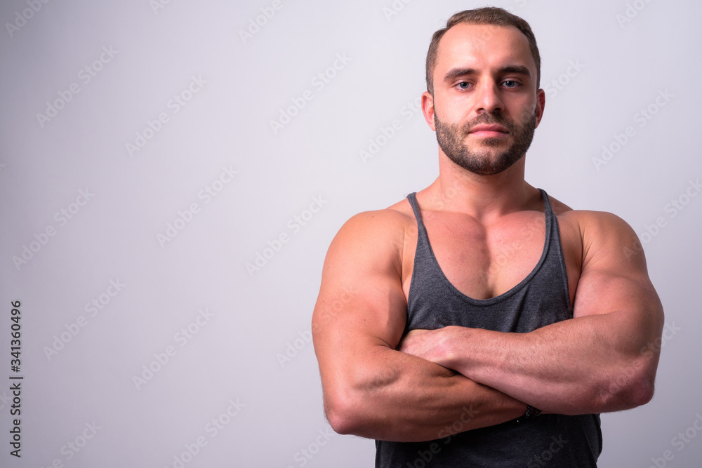 Fototapeta premium Portrait of muscular bearded man with arms crossed
