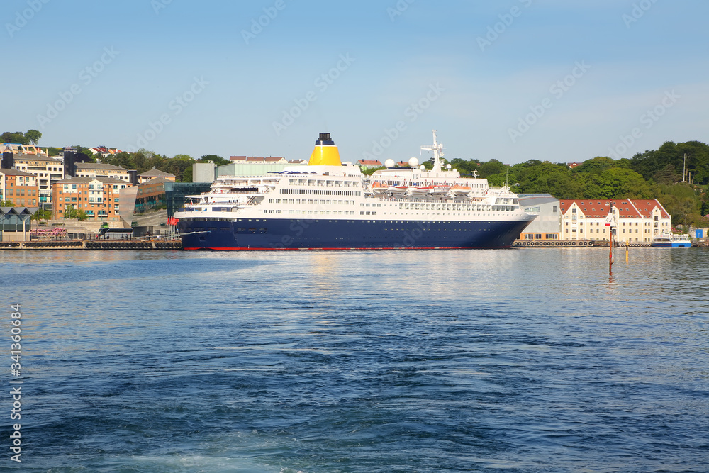 Cruise ship docked in the Port of Stavanger with the old town in the background, Stavanger, Norway.