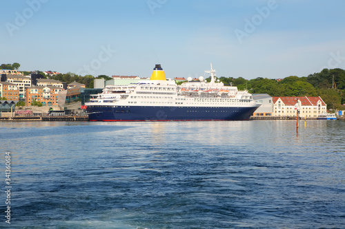 Cruise ship docked in the Port of Stavanger with the old town in the background, Stavanger, Norway. © lisastrachan