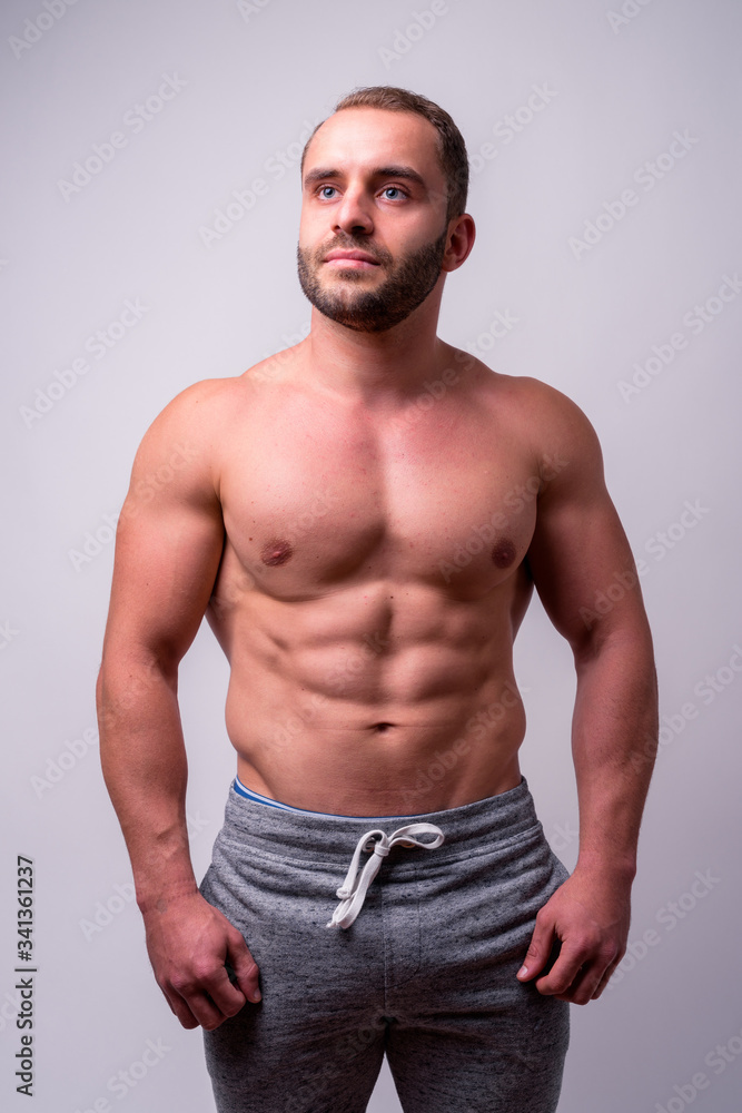 Portrait of muscular bearded man thinking shirtless