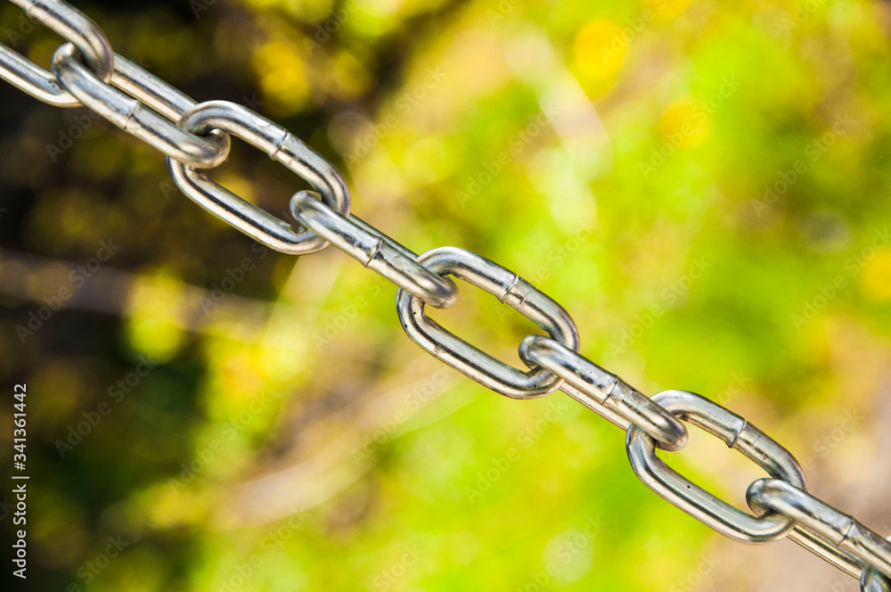 Fototapeta premium metal chain close up. the picture illustrates the inextricable link