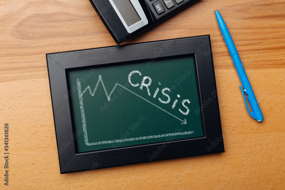 charts of economics and stock markets on a chalk board. financial crisis concept. charts of economics and stock markets on a chalk board. financial crisis concept.