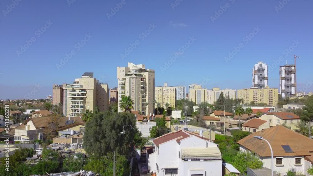 Rising to the sky over private buildings with a district of tall buildings at background in Beer Sheba Rising to the sky over private buildings with a district of tall buildings at background in Beer Sheba