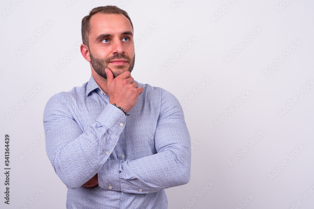 Portrait of bearded businessman thinking and looking up Portrait of bearded businessman thinking and looking up
