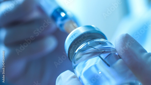 Close up:Syringe  inject to vaccine bottle