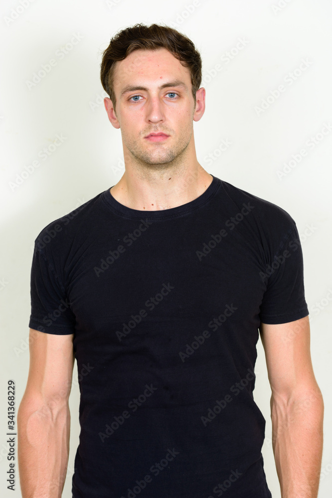 Fototapeta premium Portrait of young handsome man looking at camera