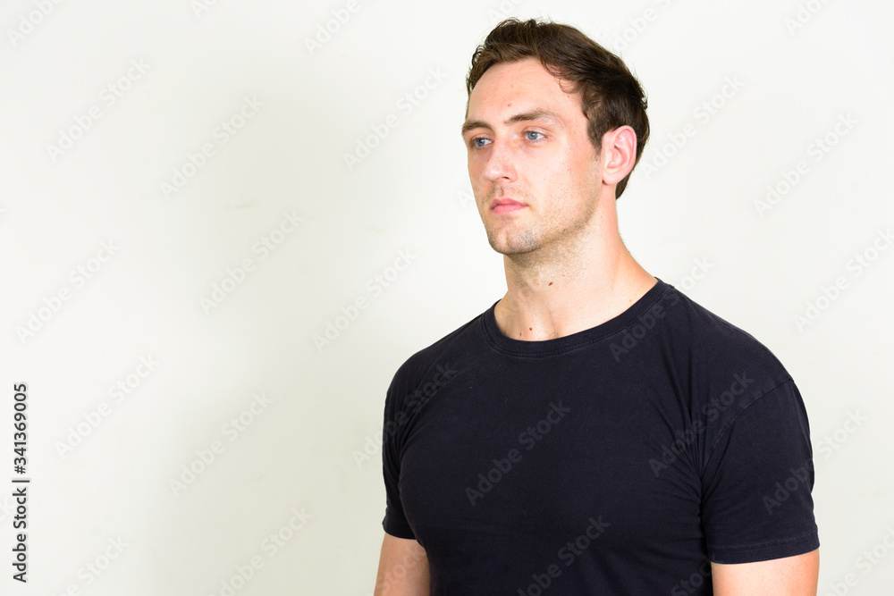 Portrait of young handsome man thinking and looking up Portrait of young handsome man thinking and looking up