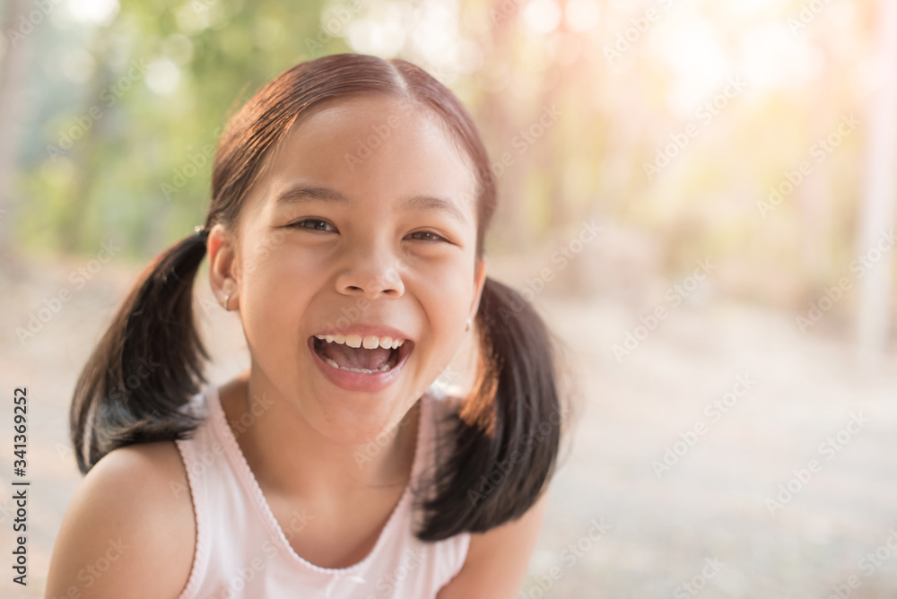 sweet little girl outdoors in the wind. portrait of attractive little student girl with beautiful. happy smiling child looking at camera - close-up, outdoors. jolly nature childhood leisure concept. sweet little girl outdoors in the wind. portrait of attractive little student girl with beautiful. happy smiling child looking at camera - close-up, outdoors. jolly nature childhood leisure concept.