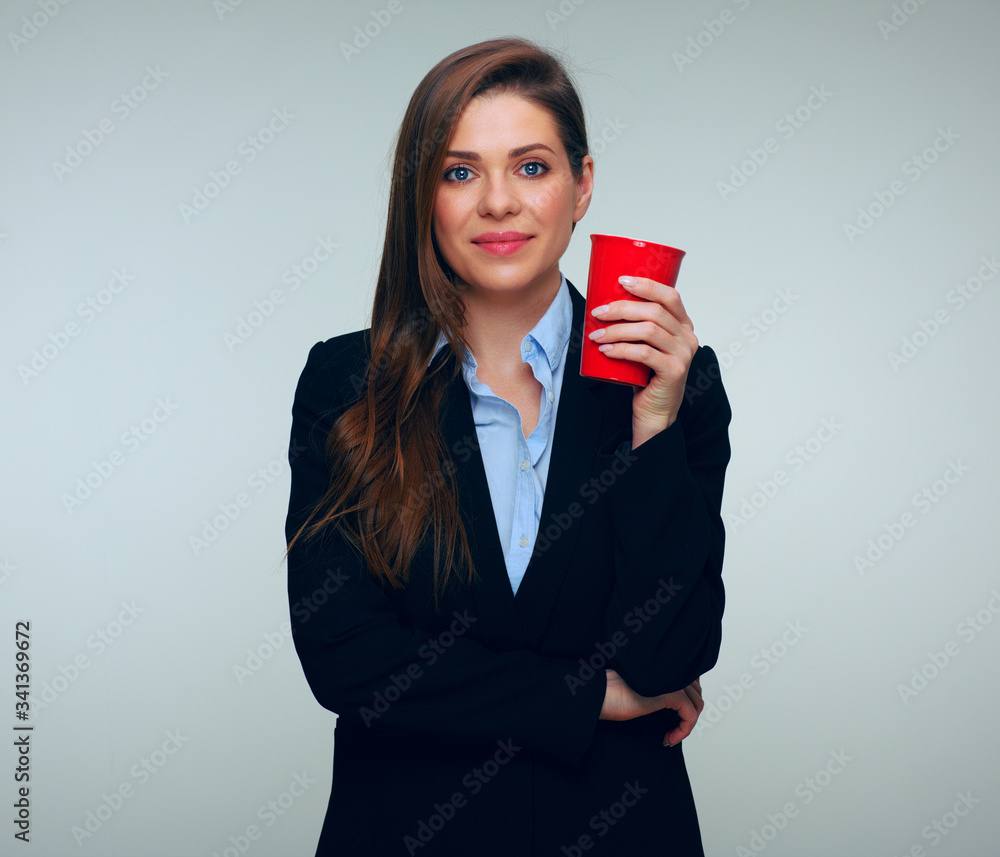 Business woman in black suit and blue shirt holding big red coffee cup. Business woman in black suit and blue shirt holding big red coffee cup.