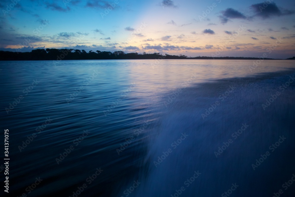 Sunset over beautiful river, speed boat point of view