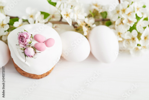 Easter sweet bread  Easter cake with flowers and gingerbread. Holidays breakfast concept with copy space. Easter greeting card template. Homemade pasques.Easter sweets on white background.