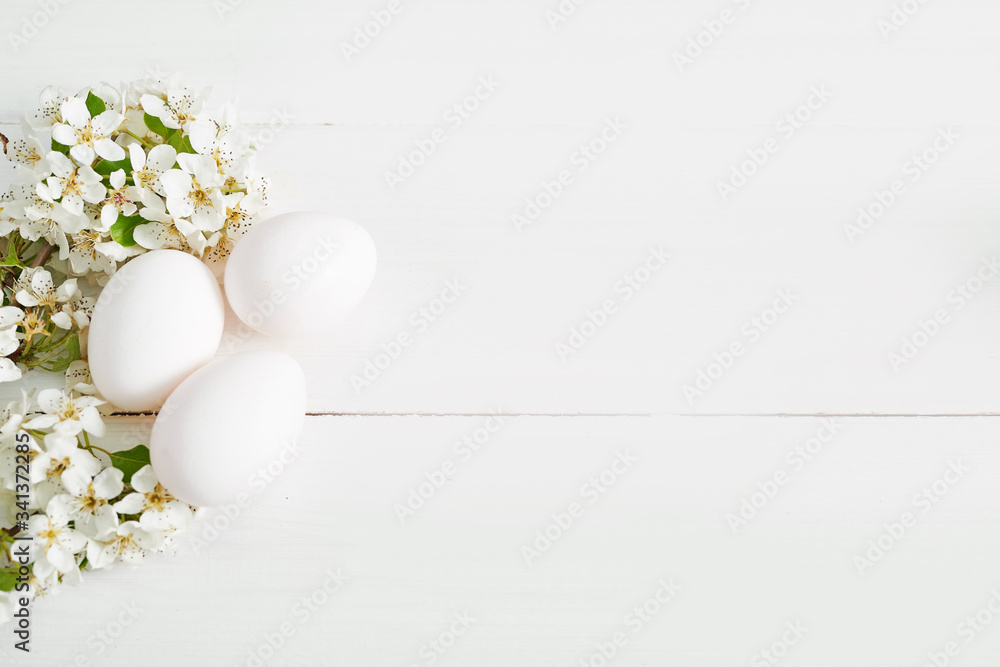 White Easter eggs and spring branch with flowers on wooden background. Spring easter greeting card.Flowers Cherry flowering.Spring flowers. Beautiful Orchard.Springtime White Easter eggs and spring branch with flowers on wooden background. Spring easter greeting card.Flowers Cherry flowering.Spring flowers. Beautiful Orchard.Springtime