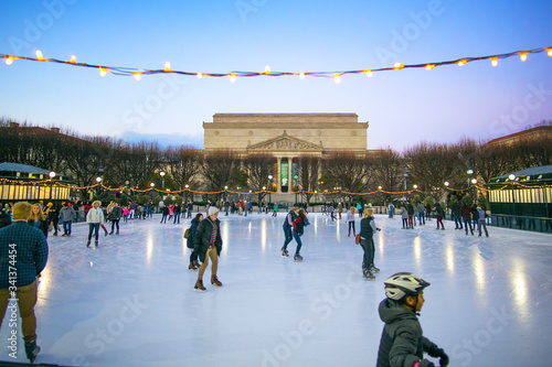 Many people in ice rink in National Gallery of Art Sculpture garden