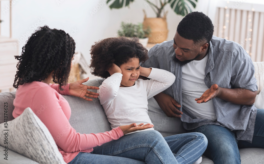 Family Upbringing. Little girl covering ears not to listen parents scolding Family Upbringing. Little girl covering ears not to listen parents scolding