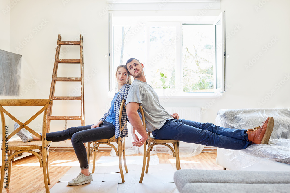 Fototapeta premium Couple takes break at renovation after relocation