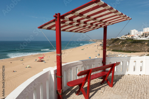 wooden bench seat with adjustable shading over the top. Santa Cruz in Lisbon Region of Portugal
