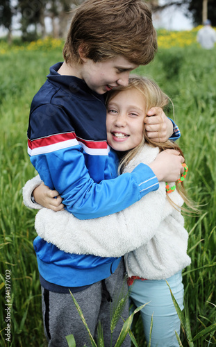 Portrait of sister with her autistic brother enjoying freedom and summer. Ending coronavirus quarantine, out of covid-19 quarantine.