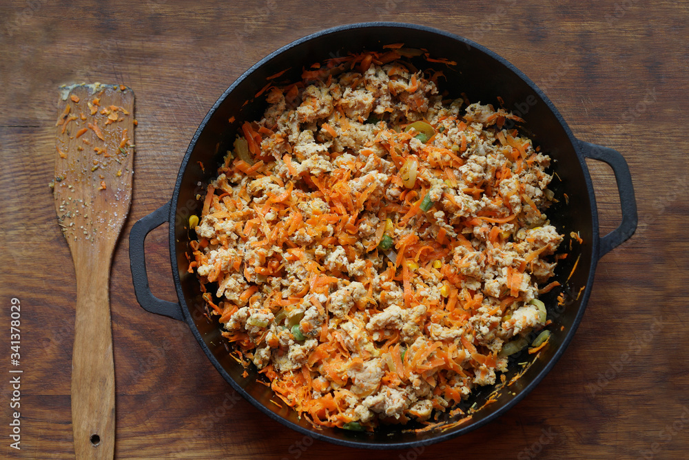 Cooking at home kitchen chicken meat side dish. Cook fry minced meat with vegetables. Cooking at home kitchen chicken meat side dish. Cook fry minced meat with vegetables.