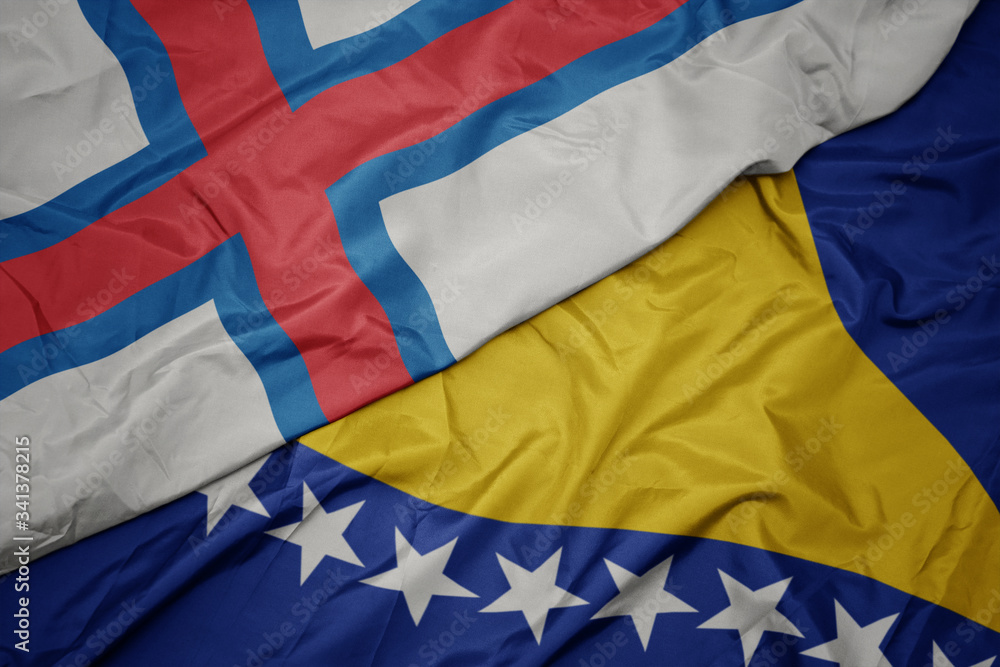 Fototapeta premium waving colorful flag of bosnia and herzegovina and national flag of faroe islands.