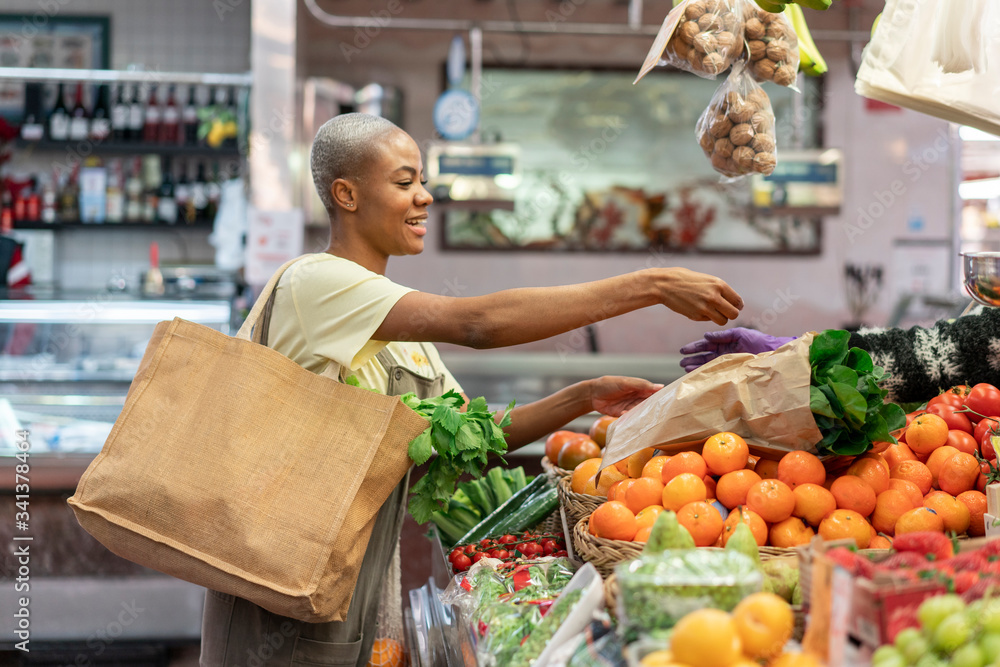 Woman buying groceries in a market hall Woman buying groceries in a market hall