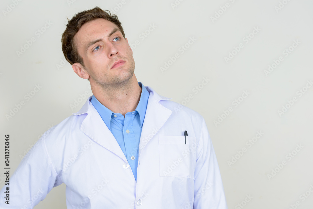 Portrait of young handsome man doctor thinking Portrait of young handsome man doctor thinking