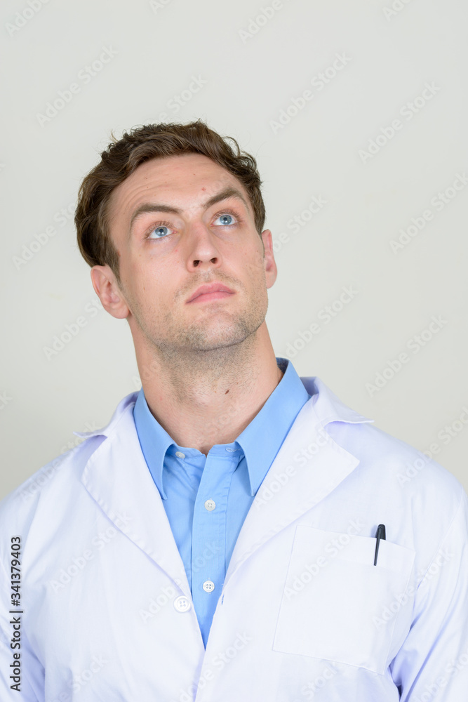 Portrait of young handsome man doctor thinking Portrait of young handsome man doctor thinking