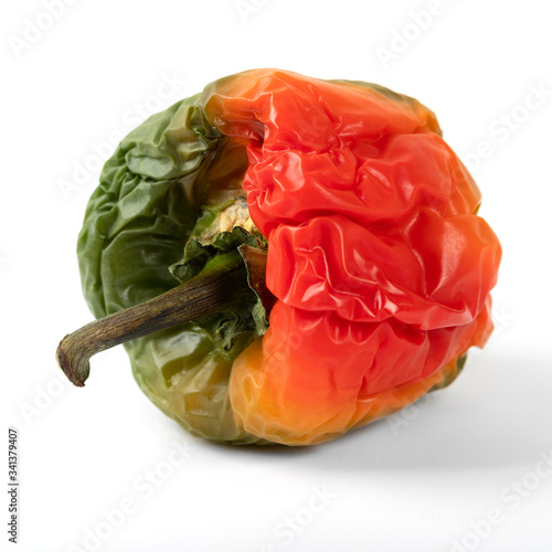 Old bell pepper on a white background