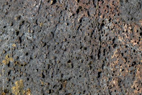 Old gray wall in holes