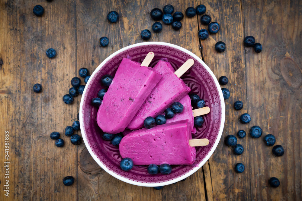Bucket of homemade blueberry popsicles Bucket of homemade blueberry popsicles