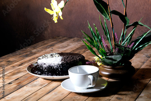 Moisture cake with topping chocolate, dry coconut with decoration on the wooden table, selective focus. photo